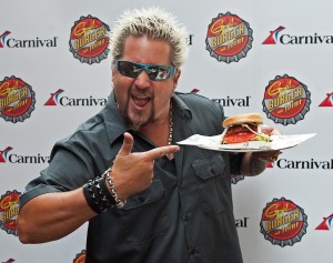 Food Network star Guy Fieri shows off his signature burger created for Carnival Cruise Lines at an event in New York, October 3, 2011. Fieri was on-hand to announce a new partnership with the cruise line called "GuyÕs Burger Joint," as part of the new Fun Ship 2.0 program, a $500 million multi-year effort that will offer guests new dining choices, more exciting bars and lounges, and entertainment options through innovative partnerships and new branded spaces. Carnival Cruise Lines/Bill Kostroun